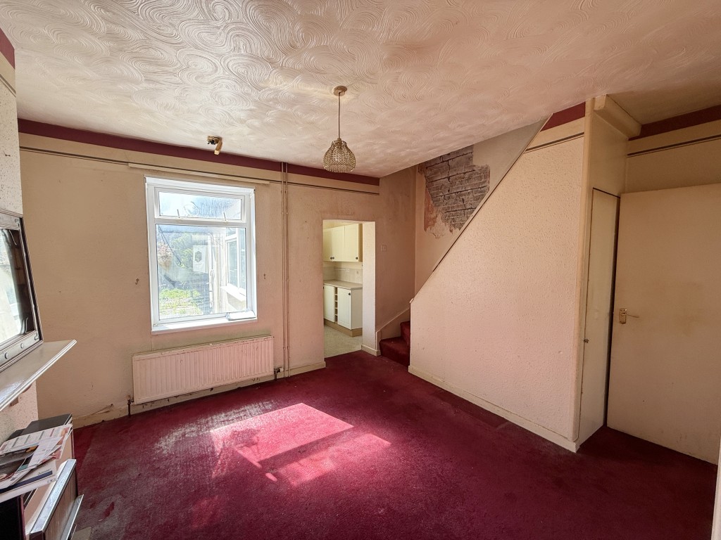 Lot: 109 - TWO-BEDROOM HOUSE IN NEED OF IMPROVEMENT - Dining room with stairs to first floor and window to garden
